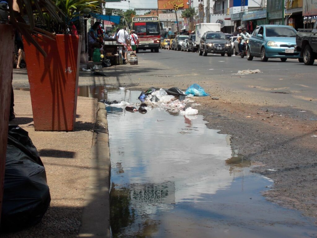 El charco de agua podrida de la mencionada esquina es común ver durante mucho tiempo l cual se ve agravada por los montones de basuras que se tiran.